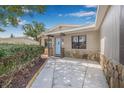 Charming single-story home with a well-manicured lawn, mature trees, and a welcoming light blue front door at 6944 80Th N Ave, Pinellas Park, FL 33781