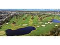 Aerial view of a golf course with manicured greens, trees and ponds at 701 Poinsettia Rd # 322, Belleair, FL 33756