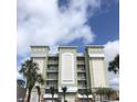 A modern, multi-story building with a clean, architectural design and serene color palette at 706 Bayway Blvd # 502, Clearwater Beach, FL 33767