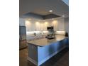 Modern kitchen with stainless steel appliances, sleek countertops, and ample cabinet space at 706 Bayway Blvd # 502, Clearwater Beach, FL 33767
