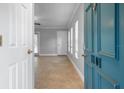 Inviting entryway with neutral tile flooring, blue door, and bright natural light at 720 Lyndhurst St # 1101, Dunedin, FL 34698