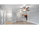Bright living room with tile flooring, ceiling fan, and an open view into the kitchen at 720 Lyndhurst St # 1101, Dunedin, FL 34698
