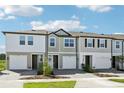 Modern townhomes present varied exteriors with driveways and manicured landscaping at 7678 Deer Valley Circle, Tampa, FL 33635