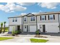 A row of modern townhomes displays varied exterior designs with driveways and landscaping at 7678 Deer Valley Circle, Tampa, FL 33635