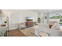 Elegant living room showcasing a decorative wall, modern furniture, and a view of the landscaped backyard at 7803 Wheat Stone Dr, Zephyrhills, FL 33540