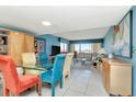 Open-concept dining area features a glass table, colorful chairs, and expansive windows with bright, natural lighting at 7893 Sailboat Key S Blvd # 304, South Pasadena, FL 33707