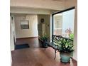 Inviting lobby area with bench seating, lush plants, and brick flooring providing a welcoming atmosphere at 7893 Sailboat Key S Blvd # 304, South Pasadena, FL 33707