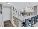 Stylish kitchen featuring a marble counter with bar seating, stainless steel appliances, and modern pendant lights at 900 Maclaren N Dr # D, Palm Harbor, FL 34684