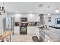 Bright kitchen featuring stainless steel appliances, stylish countertops, and white cabinets at 900 Maclaren N Dr # D, Palm Harbor, FL 34684