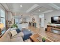 Spacious living room with modern furnishings, recessed lighting, and seamless open floorplan to kitchen at 910 E Crenshaw St, Tampa, FL 33604