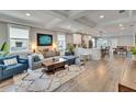 Open-concept living room with hardwood floors, recessed lighting, and a seamless transition to the modern kitchen at 910 E Crenshaw St, Tampa, FL 33604