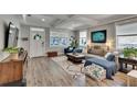 Inviting living room featuring ample natural light, stylish decor, and seamless open floorplan to kitchen at 910 E Crenshaw St, Tampa, FL 33604