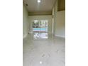 Bright living room with elegant marble floors and sliding glass doors overlooking the pool at 10444 Fordham St, Spring Hill, FL 34608
