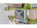An aerial view showing solar panels on the roof and a backyard pool of a well-maintained home at 1205 Sweet Gum Dr, Brandon, FL 33511