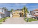 Charming front exterior featuring a neutral color scheme, paver driveway, and neat landscaping and solar panels at 1205 Sweet Gum Dr, Brandon, FL 33511