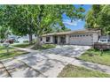 Charming home with a spacious driveway, large trees, and a well-kept lawn, perfect for outdoor enjoyment at 15820 Sapwood St, Tampa, FL 33624