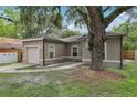 Single-story home with stucco exterior, attached garage, and mature landscaping at 1605 Prescott S St, St Petersburg, FL 33712
