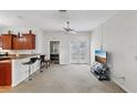 Bright living room features a kitchen breakfast bar, neutral carpet, and natural light at 1605 Prescott S St, St Petersburg, FL 33712