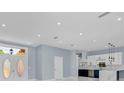 Bright, open-concept living space features a modern kitchen and view of the front entrance at 1716 Bermuda Ct, Safety Harbor, FL 34695