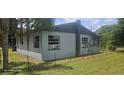 Back of the house with visible windows, chimney, external AC units, and chain-link fence at 1908 S Kingsway Rd, Seffner, FL 33584
