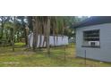 View of a white storage shed in the backyard, with chain link fencing at 1908 S Kingsway Rd, Seffner, FL 33584