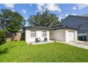Charming home featuring a well-manicured lawn and cozy front patio seating at 206 N Beverly Ave # 1/2, Tampa, FL 33609