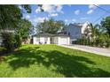 Cozy home featuring a well-manicured lawn and charming front patio seating at 206 N Beverly Ave # 1/2, Tampa, FL 33609
