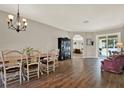 Spacious dining room with hardwood floors, a chandelier, and plenty of natural light at 20835 Lake Talia Blvd, Land O Lakes, FL 34638