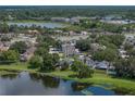 Beautiful aerial view of lakefront property with mature trees and easy access to the highway at 22829 Saint Thomas Cir, Lutz, FL 33549
