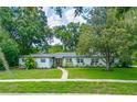 Inviting single-story home featuring a well-maintained lawn and charming curb appeal at 2308 Cape Bend Ave, Tampa, FL 33613