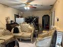 Cozy living room featuring tile floors, ceiling fan, and vintage furniture at 2909 N 11Th St, Tampa, FL 33605