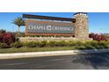 Welcoming entrance sign for Chapel Crossings, surrounded by lush landscaping and greenery at 31504 Hayman Loop, Wesley Chapel, FL 33545