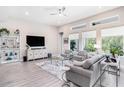 Bright living room with large windows, modern furnishings, and stylish decor, creating a welcoming atmosphere at 3603 Tour Trce, Land O Lakes, FL 34638