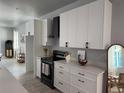 Spacious kitchen with white cabinets, sleek black appliances, and ample countertop space at 4200 N 15Th St, Tampa, FL 33610