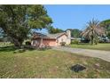 Charming single-story home with a lush lawn and mature trees in a quiet neighborhood at 4355 Odin St, Spring Hill, FL 34608