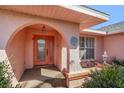 Inviting front porch with decorative archway, lantern and textured walls for an elegant entrance at 4355 Odin St, Spring Hill, FL 34608