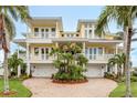 Beautiful home with two two-car garages, balconies, and circular brick drive at 442 Midway Is, Clearwater Beach, FL 33767