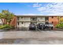 Well-maintained condo building with ample parking, manicured landscaping, and a classic brick and white facade at 4540 Overlook Ne Dr # 246, St Petersburg, FL 33703