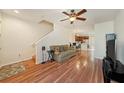 Bright living room with hardwood floors, ceiling fan, and open floor plan at 4668 66Th N Pl, Pinellas Park, FL 33781