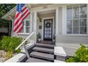 Inviting front entrance featuring a black front door and an American flag at 5101 N Suwanee Ave, Tampa, FL 33603
