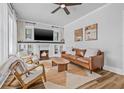 Comfortable living room showcasing a fireplace, hardwood floors, and stylish decor at 5101 N Suwanee Ave, Tampa, FL 33603