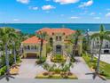 Stunning waterfront estate with lush landscaping, circular drive, and beautiful Mediterranean-style architecture at 611 1St S Ave, Tierra Verde, FL 33715