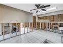 Open-concept kitchen area with tile flooring and ceiling fan ready for renovation at 7400 Locust Ne St, St Petersburg, FL 33702