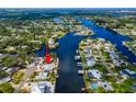 Aerial view of waterfront property with a private boat dock, with canal access to open water at 805 Leisey Cir, Ruskin, FL 33570