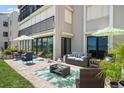Beautiful outdoor patio area with comfortable seating, decorative rugs and a view of the water at 825 S Gulfview Blvd # 104, Clearwater Beach, FL 33767