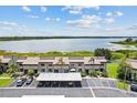 Breathtaking aerial view of townhomes overlooking a serene lake and well-manicured lawns at 9209 Seminole Blvd # 13, Seminole, FL 33772