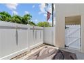 Enclosed patio with white privacy fence and a patterned outdoor rug at 9209 Seminole Blvd # 13, Seminole, FL 33772