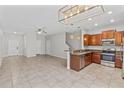 Open-concept kitchen boasts stainless steel appliances and granite countertops perfect for modern living at 9768 Pembrooke Pines Dr, Sun City Center, FL 33573