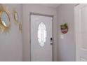 Elegant front door with decorative glass panel and welcoming decor at 1004 Osage St, Clearwater, FL 33755