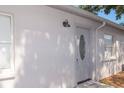 The side entrance of the home featuring a white front door at 1004 Osage St, Clearwater, FL 33755
